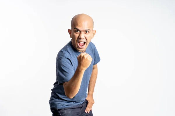 Excited asian bald man screaming with one hand clenched — Stock Photo, Image