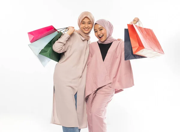 Muslim bestfriend happy holding a shopping bag over white background — ストック写真