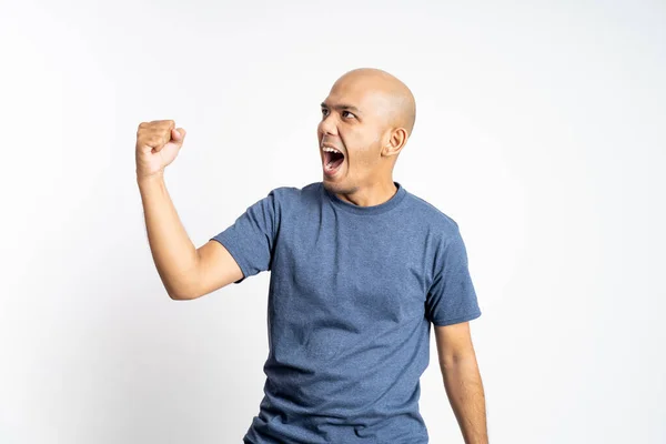 Excited bald man screaming with one hand clenched — Stock Photo, Image