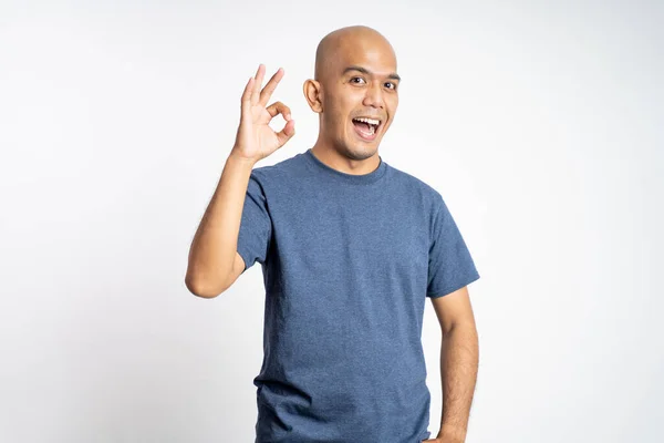 Smiling asian bald man opening mouth with okay gesture — Stock Photo, Image