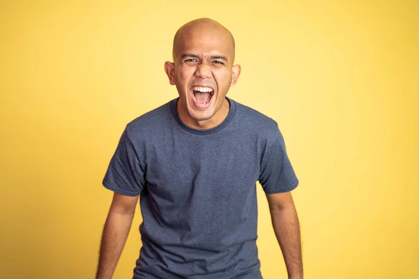 Bald asian man laughing with mouth open on isolated background — Stock Photo, Image