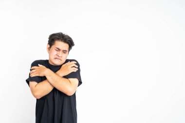 Adam iki kolunu birden tutarken titriyor.