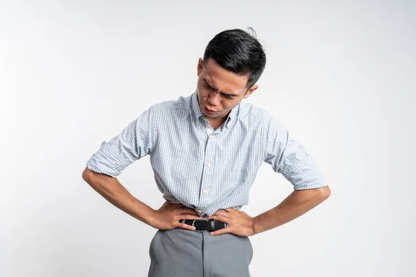 Man having stomachache holding his stomach with two hands — Stock Photo, Image