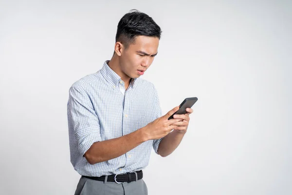 Zavaros fiatal üzletember, miközben nézi az okostelefon — Stock Fotó