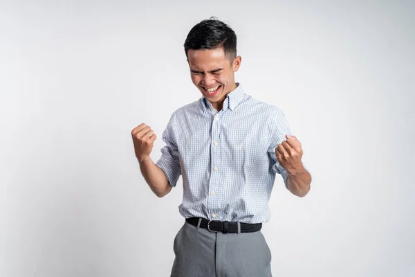 Upphetsad asiatisk ung man med två händer spända — Stockfoto