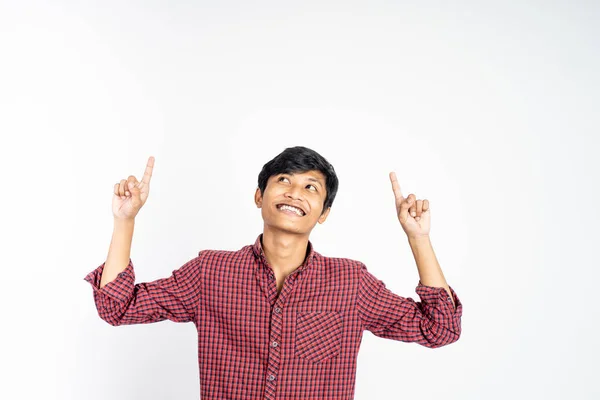 Excited young man with two fingers pointing up — Stock Photo, Image