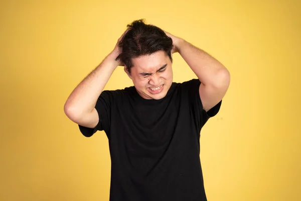 Stressed asian young young man holding head — Stock Photo, Image
