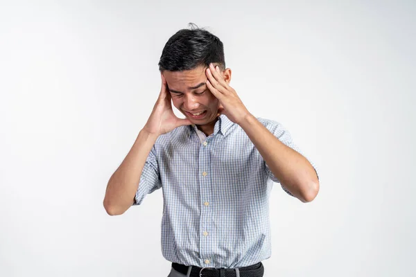 Stressed asian young young man holding head — Stock Photo, Image