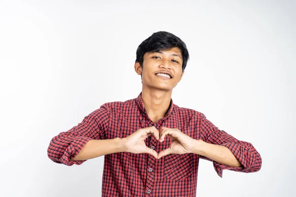 Man forming a heart with finger gestures on isolated background — Stock Photo, Image