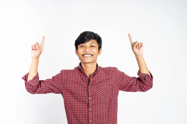 Excited young man with two fingers pointing up — Stock Photo, Image