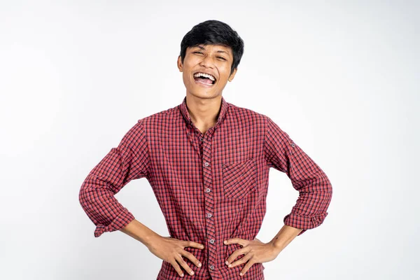 Happy asian young man laughing naturally on studio background — Stock Photo, Image