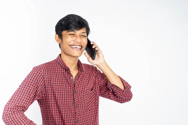 Człowiek śmieje się podczas rozmowy telefonicznej na odosobnionym tle — Zdjęcie stockowe