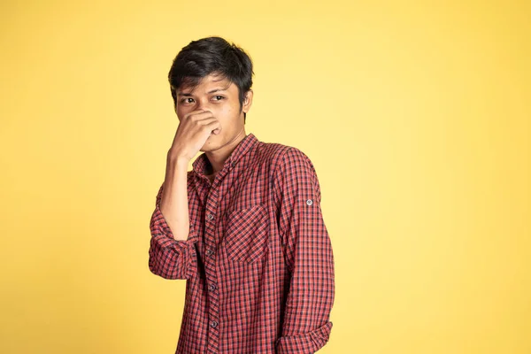 Man cover his nose and feeling disgusted by the smell — Stock Photo, Image