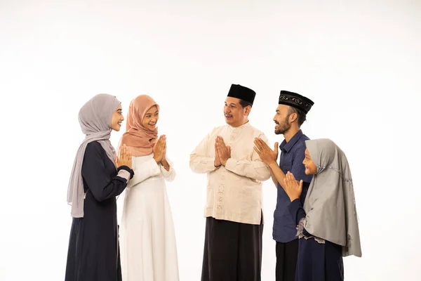 Muslim family shake hand on idul fitri celebration — Stock Photo, Image