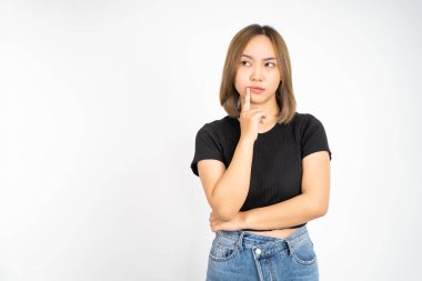 Thoughtful Asian woman poses against isolated background