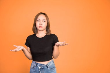 asian woman opening two palms feeling uncertain