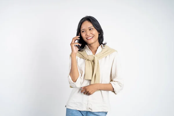 Mulher fazendo uma chamada usando um telefone celular em fundo isolado — Fotografia de Stock