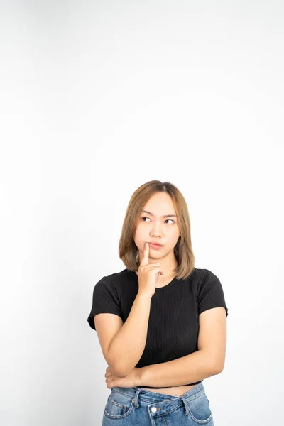 Thoughtful Asian woman poses against isolated background — Foto de Stock