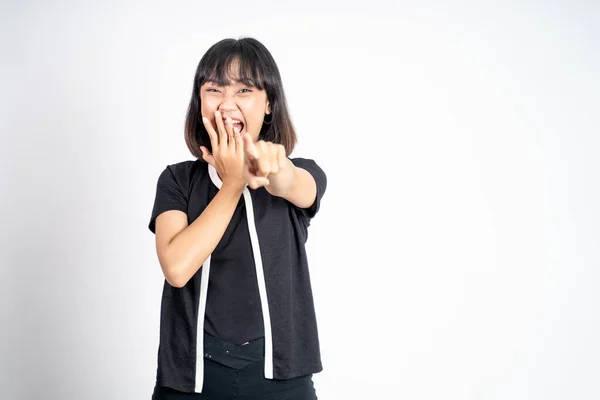 Woman with finger pointing at frong and laughing at something — Foto Stock