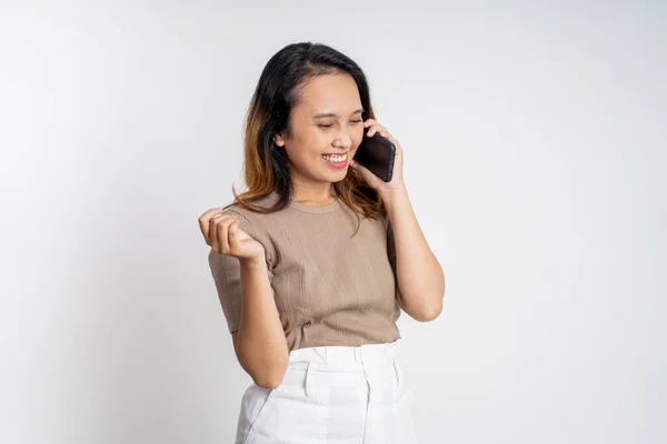 Woman making a call using a cell phone on isolated background — Stockfoto