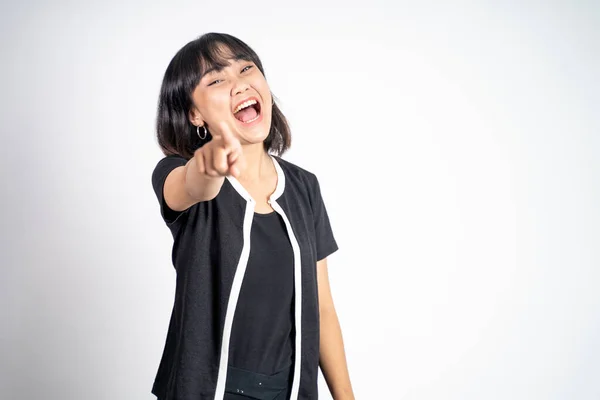 Woman with finger pointing at frong and laughing at something — Foto Stock