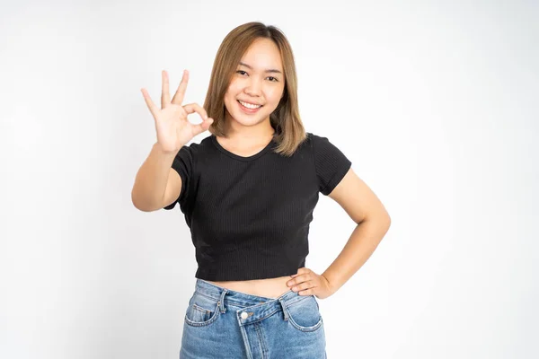 Woman showing oke gesture with hands near eye looks imitating binocular — Stockfoto