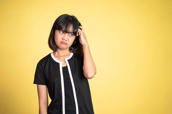 Thoughtful Asian woman poses against isolated background — ストック写真