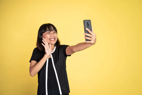 Woman make a video call using mobile phone with saying hello gesture — Foto Stock