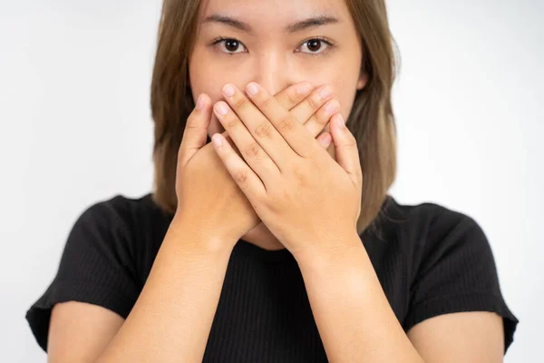 Portrait of asian woman covering her mouth with hands — Fotografia de Stock