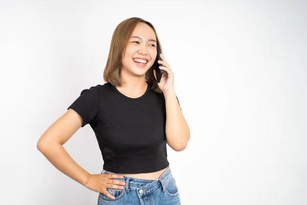 Woman making a call using a cell phone on isolated background — Stockfoto