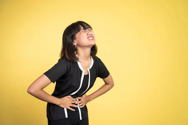 Woman having her period holding her stomach in pain — Stockfoto