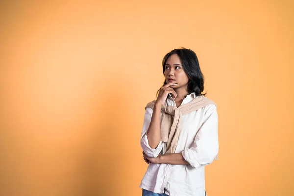 Beautiful woman on isolated background with thoughtful expression — 스톡 사진