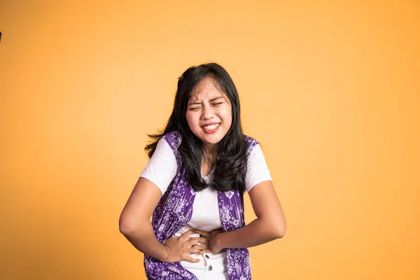 Woman having her period holding her stomach in pain — Foto Stock
