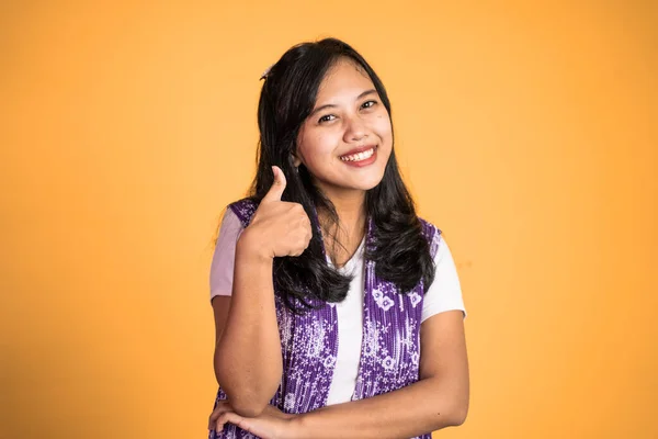 Woman stand with thumbs up on isolated background — Stock fotografie