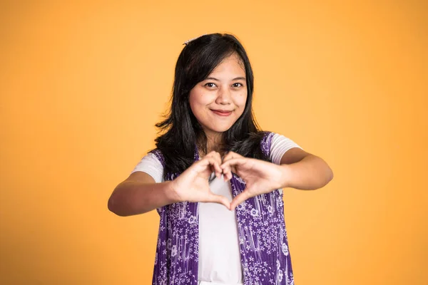 Woman smiling in heart shape with fingers on isolated — Foto Stock