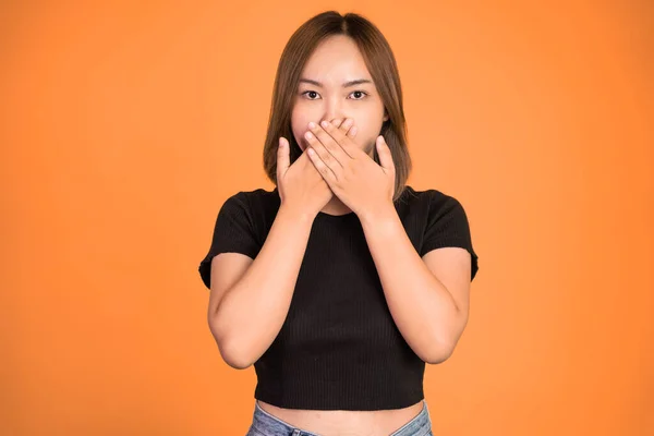 Portrait of asian woman covering her mouth with hands — Fotografia de Stock