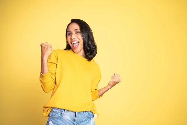 Asian woman clenching hands while celebrating success — Stockfoto