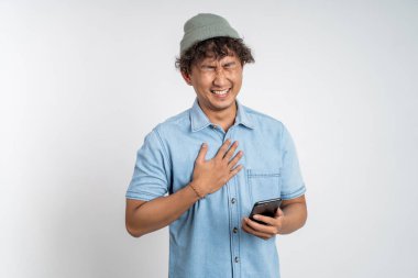 Genç adam cep telefonuna bakarken çok güler.