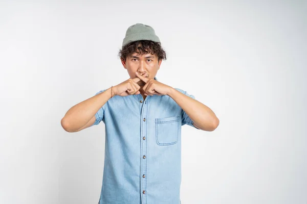 Man with hands covering mouth standing over isolated background — Stock fotografie