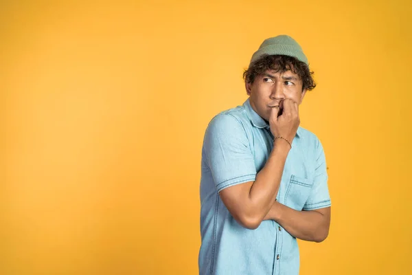 Unsure asian young man thinking on isolated background — Stock Photo, Image