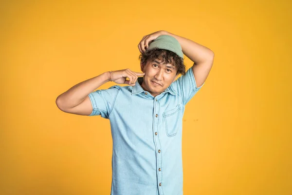 Confident young asian man pose on isolated background — Stockfoto