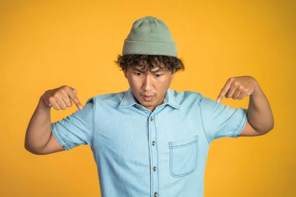 Man with two fingers pointing down on isolated background — Stock Photo, Image