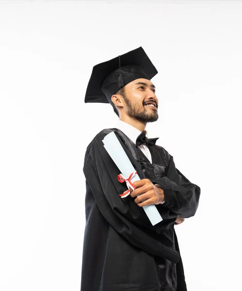 Confident Asian Male Graduate Wearing Toga Holding Roll Certificate Paper — Stock Fotó