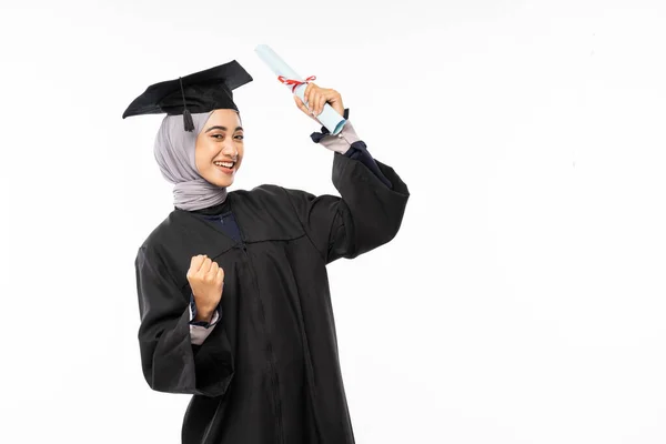 Female Bachelor Graduate Wearing Toga Hand Clenched While Holding Roll — Stok fotoğraf