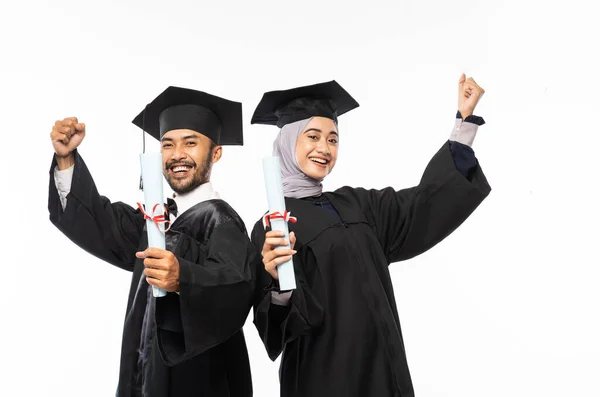 Two Confident Graduates Wearing Togas Holding Certificate While Celebrating Isolated — Stok fotoğraf