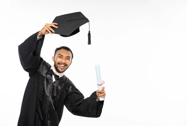 Young Graduate Male Student Toga Holding Hat Standing White Background — Stok fotoğraf
