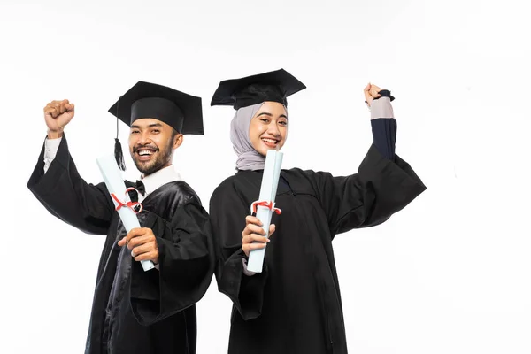 Happy Graduates Wearing Togas Holding Certificate While Celebrating University Graduation — Stok fotoğraf