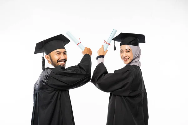 Two Graduate Students Wearing Togas Holding Certificate While Looking Back — Φωτογραφία Αρχείου