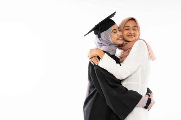 Happy Asian Female Graduate Student Wearing Toga Hugging Her Mother — 스톡 사진