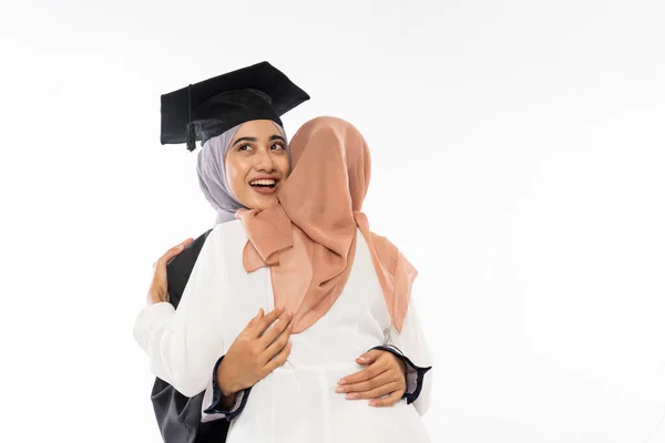 Happy Graduate Female Student Wearing Toga Hugging Her Friend Isolated — Φωτογραφία Αρχείου